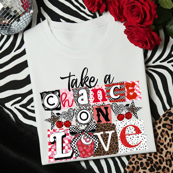 Take A Chance On Love SET DTF Heat Transfer, colorful and playful design with various patterns and images including cherries, stars, and bows, on a white t-shirt.