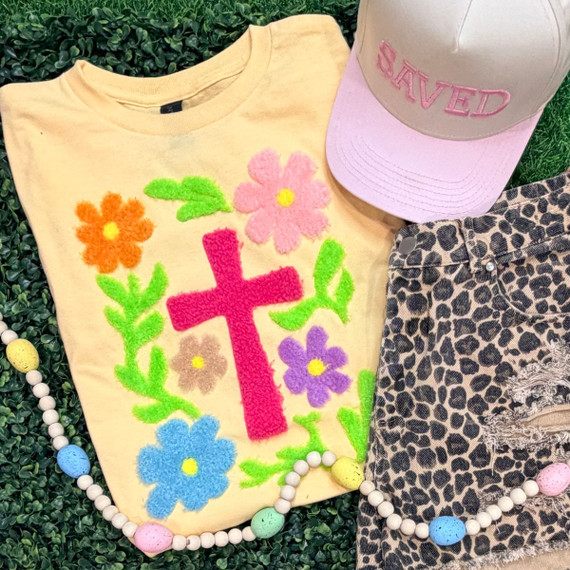 Floral Cross Fluffy Chenille Patch, colorful floral embroidered patch with pink cross on a light yellow t-shirt.