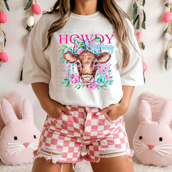 Howdy Spring Cow DTF Heat Transfer, colorful and vibrant cow head design with floral accents on a white t-shirt.