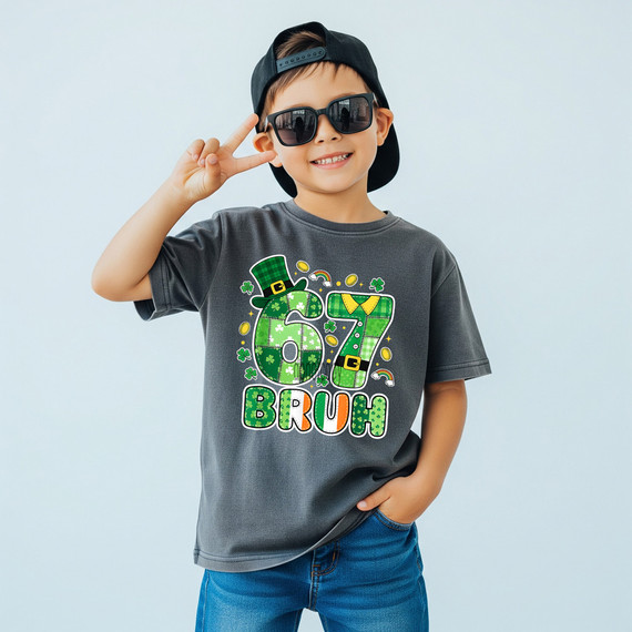 Product 67 Bruh DTF Heat Transfer, a boy wearing a gray t-shirt with green, orange, and white St. Patrick's Day-themed design featuring the number 67, leprechaun hat, and the words 'BRUH'.