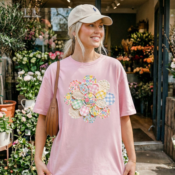 Faux Fabric Patchwork Flower DTF Heat Transfer, close-up of colorful patchwork flower design on a pink T-shirt worn by a woman at a flower shop