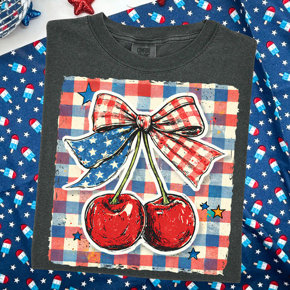 Patriotic Cherry Bow DTF Heat Transfer, colorful Red, White, and Blue design featuring cherries with an American flag bow on a gray T-shirt.