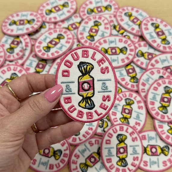 Doubles & Bubbles Embroidered HAT/POCKET Patch, colorful fabric patch featuring a candy illustration with pink, yellow, and black embroidery.