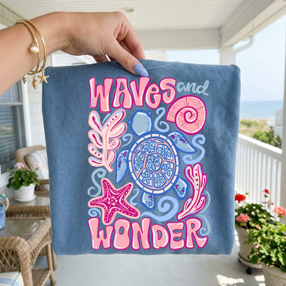 Waves And Wonder DTF Heat Transfer, colorful nautical sea turtle, starfish, shell, and seaweed design on a blue fabric surface.