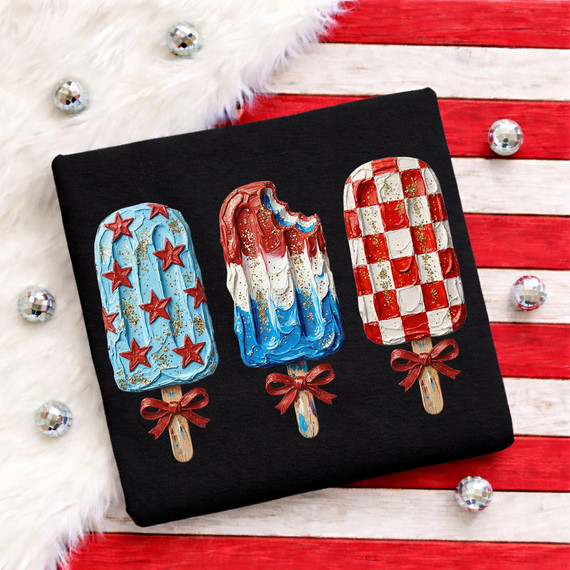 Faux Painted Patriotic Popsicles DTF Heat Transfer, detailed image of three painted popsicle designs in red, white, blue, and gold on a black fabric, for patriotic celebrations.