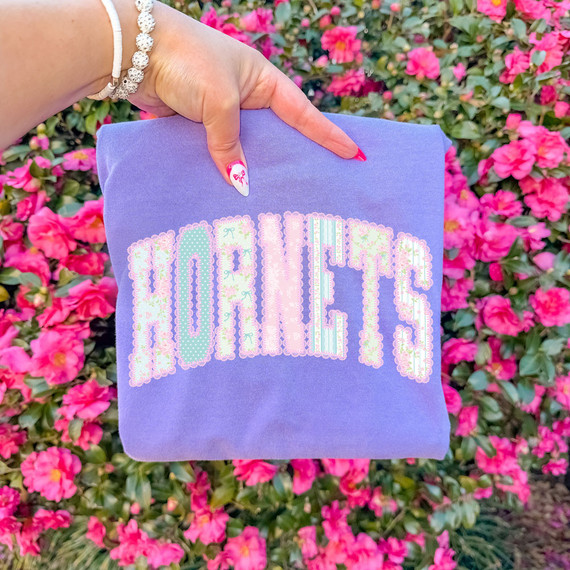 Cottagecore Patterned Hornets DTF Heat Transfer, purple fabric with colorful floral pattern spelling Northeast.