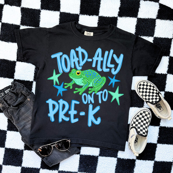 Toad-Ally On To BLUE DTF Heat Transfer, colorful graphic T-shirt with a frog and stars design for preschool on black background.