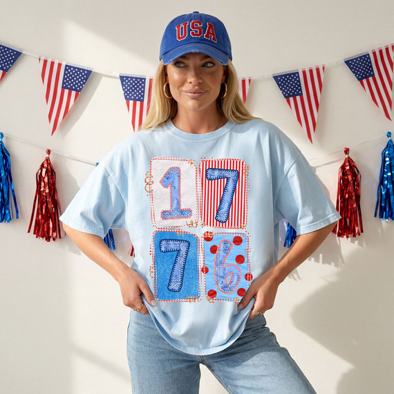 1776 Patchwork DTF Heat Transfer, patriotic-themed patchwork design on a light blue T-shirt with numbers 1, 7, 7, 6 for Independence Day celebration.