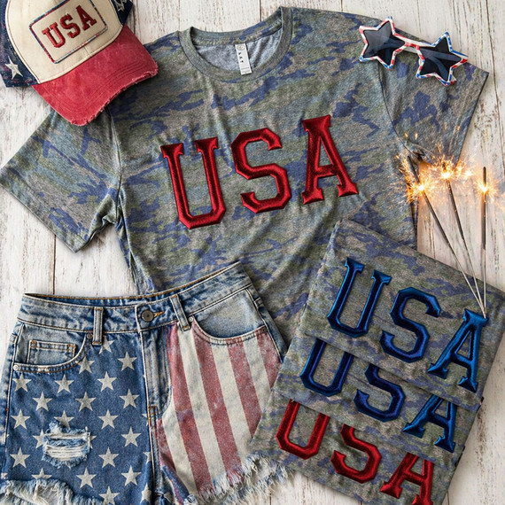 USA metallic puff heat transfer with raised red and blue lettering on camo shirt styled with patriotic denim shorts