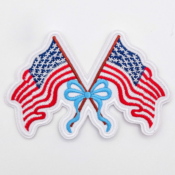 American Flag Bow Embroidered Hat Patch, patriotic coquette style patch featuring dual embroidered American flags with a blue bow in the center, designed for boutiques and hat bars.
