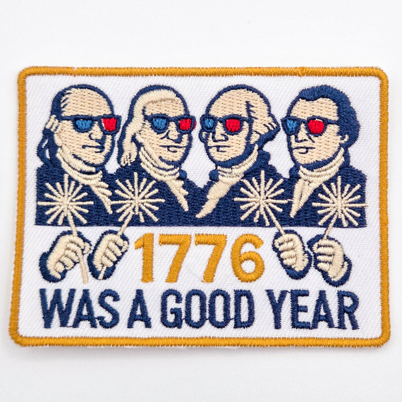 1776 Was a Good Year Embroidered Patch – Vintage Patriotic Statement Patch for Hat Bars & Boutiques, featuring four figures wearing sunglasses and holding sparklers with patriotic colors, and the text '1776 Was a Good Year' embroidered below.