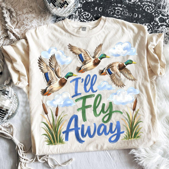 I'll Fly Away Mallard DTF Heat Transfer, colorful duck-themed design with flying mallard ducks, clouds, and grass on a white t-shirt.