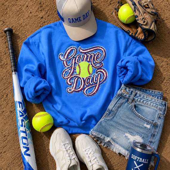 Royal blue sweatshirt featuring a sparkling Game Day softball sequin patch with neon softball detail, styled for softball moms and boutique game day apparel.