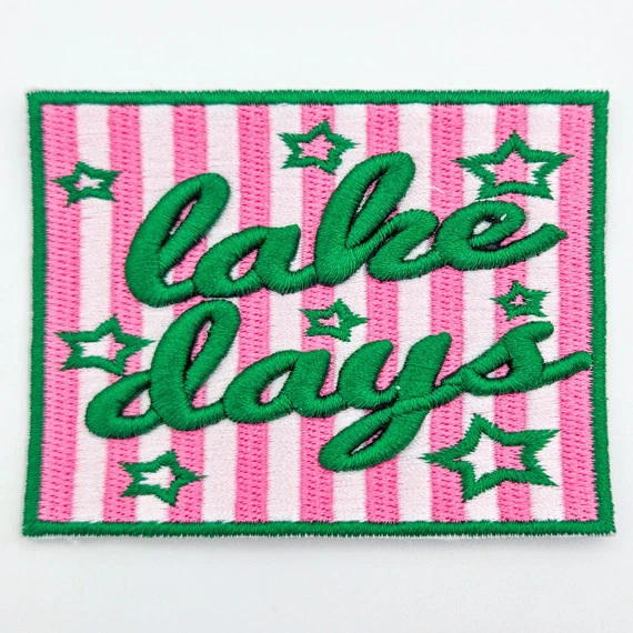 Lake Days Puff Embroidered Patch – Boutique & Hat Bar Favorite, colorful embroidered patch with pink and white striped background, green cursive text, and star accents.