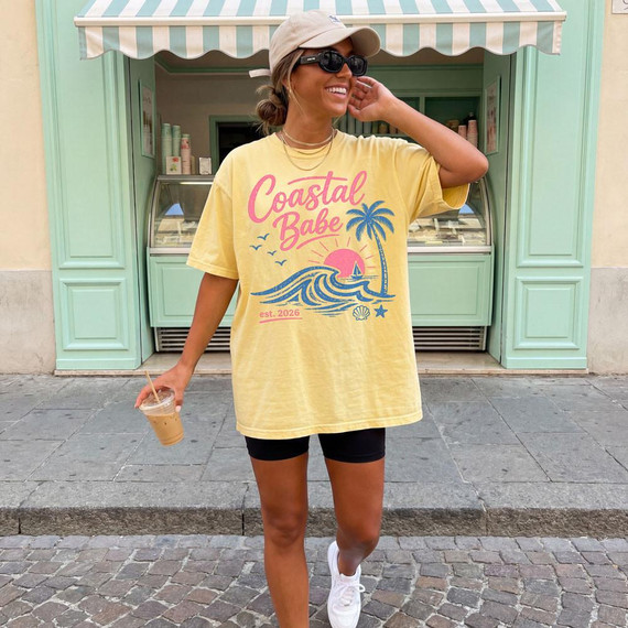 Product Coastal Babe DTF Heat Transfer, yellow T-shirt with Tropical Beach Design including a palm tree, ocean waves, and sunset.