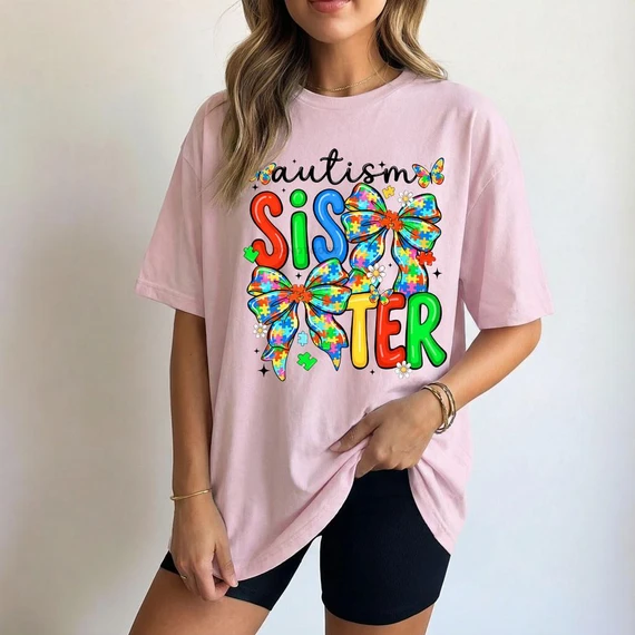Autism Sister Coquette DTF Heat Transfer, colorful design with bows and puzzle pieces on a pink t-shirt representing autism awareness and sister support.
