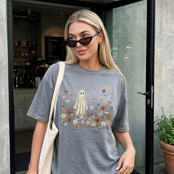 Floral Ghost DTF Heat Transfer, a detailed image of a product featuring a ghost figure surrounded by colorful flowers on a grey T-shirt.