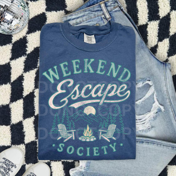 Weekend Escape Society DTF Heat Transfer, graphic T-shirt with outdoor camping scene featuring mountains, trees, campfire, and chairs.