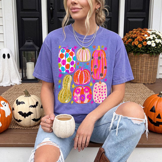 Preppy Patterned Pumpkins DTF Heat Transfer, colorful pumpkin designs on a purple t-shirt.