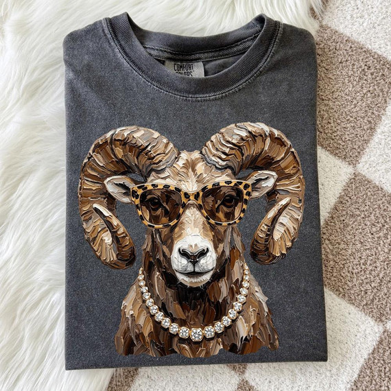 Glam Ram DTF Transfer, detailed image of a gray sweatshirt with a ram wearing sunglasses, a gemstone necklace, and the DTF transfer design on the front.
