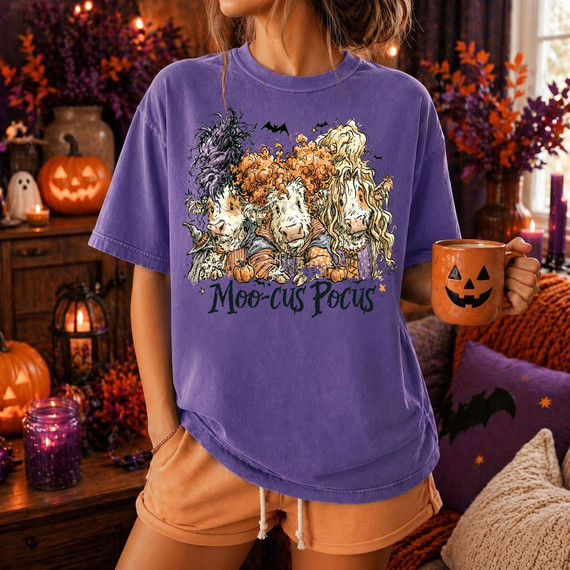 Moo-Cus Pocus Halloween DTF Heat Transfer, Halloween-themed graphic on a purple T-shirt featuring three dogs with spooky costumes.