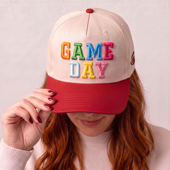 Game Day Puff Embroidered Hat Patch | Heat Press Patch, colorful embroidered patch on baseball cap with red brim, woman holding hat, casual fashion accessory.