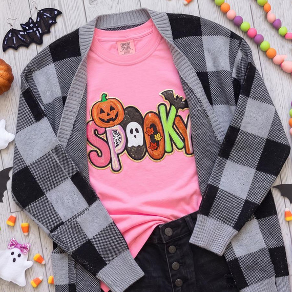 Spooky Halloween Sequin Patch, colorful Halloween-themed sequin patch on pink T-shirt with jack-o'-lantern, ghost, and bat designs.