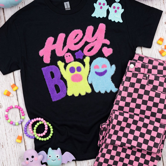 Hey Boo fluffy Halloween heat press patch with pink purple yellow and blue ghosts displayed on a black T-shirt
