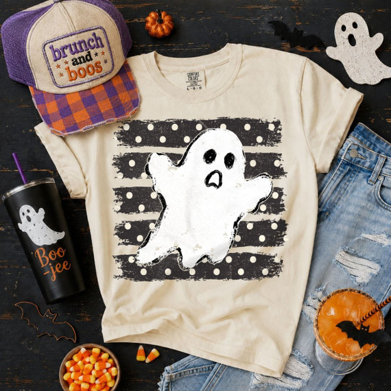 Distressed ghost DTF transfer with black and cream polka dot striped background on a tan Halloween t-shirt