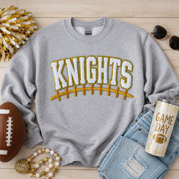 Knights White Chenille Gold Sequin Football Apparel Patch, decorative patch featuring the word 'Knights' with a football design using gold sequins and chenille fabric on a gray sweatshirt.