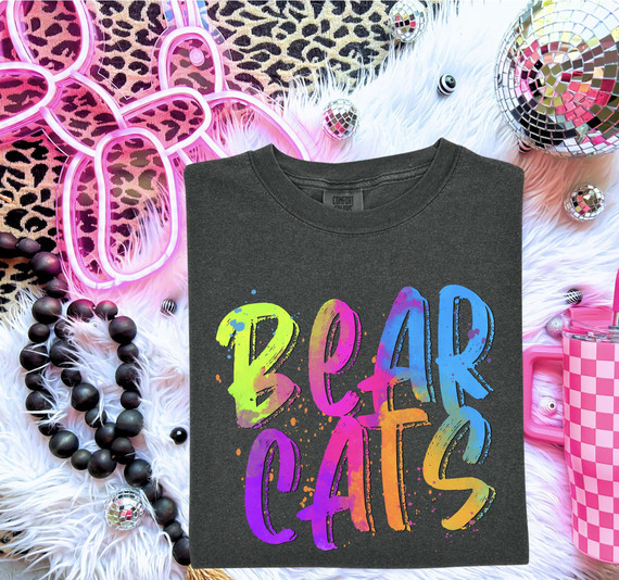 Bright Color Mascot A-G DTF Transfers | Neon Watercolor School Spirit Collection, a black T-shirt with colorful neon watercolor text saying 'BEAR CATS' on a vibrant, decorated background.