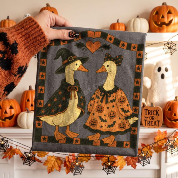 Folk Art Halloween Geese DTF Transfer, country farmhouse fall design featuring two anthropomorphic geese dressed in Halloween costumes with pumpkins and bats, perfect for fall decor.