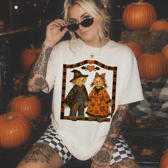 Scarecrow Couple DTF Transfer, vintage fall country Halloween design featuring scarecrow dolls dressed in Halloween costumes with pumpkins in the background.