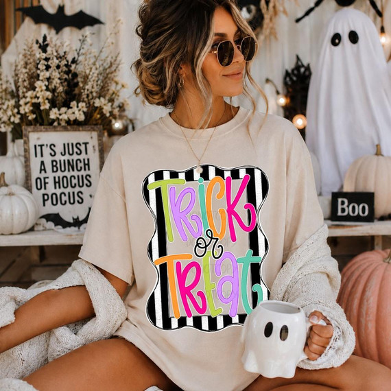 Trick or Treat DTF Transfer with Colorful Retro Halloween Design, featuring vibrant multicolored text on a black and white striped background, worn by a woman in Halloween-themed setting.