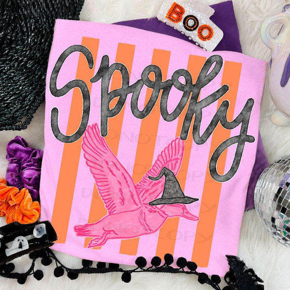 Spooky Duck DTF Transfer, whimsical Halloween design featuring a pink flying duck wearing a witch hat on a pink and orange striped background.