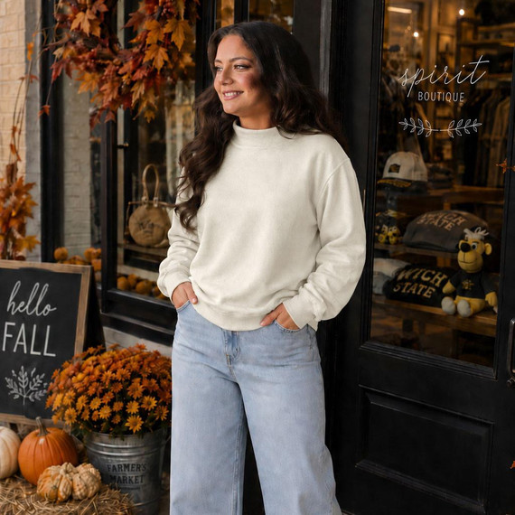 Blank Mockneck Sweatshirt — Preorder | Multiple Colors, woman wearing a cream-colored mockneck sweatshirt and light blue jeans, standing outside a boutique decorated for fall with pumpkins and autumn leaves.