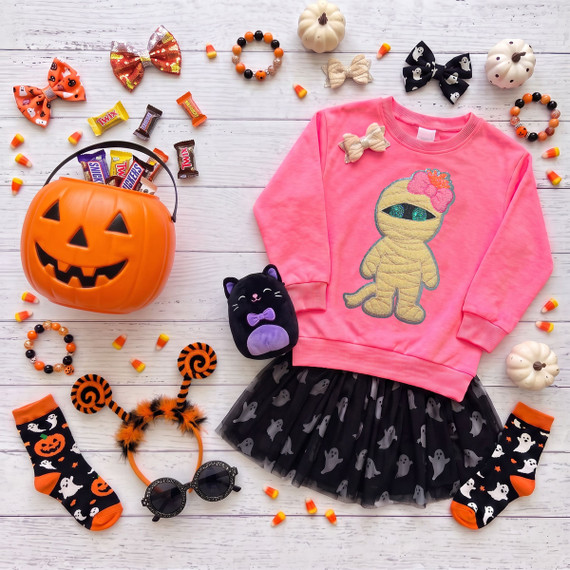 9 inch youth Halloween mummy patch with dimensional cream wrapping, teal sequin eyes, pink bow and sparkling trim