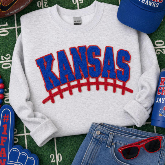 Kansas Football Chenille Patch | Red Blue Spirit Patch, embroidered sweatshirt featuring 'KANSAS' in blue letters with red outline and a red football design line beneath.