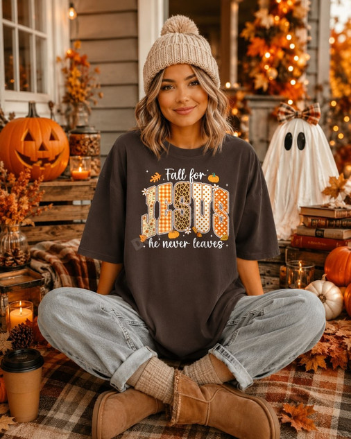 Fall for Jesus He Never Leaves DTF transfer with leopard print, gingham, and floral patterned lettering on a brown shirt