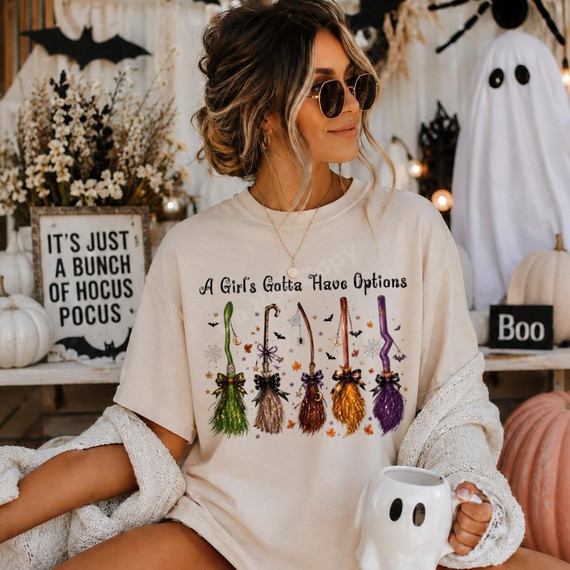 Girl's Gotta Have Options Halloween DTF Transfer with Witch Broom Design, colorful broomstick illustration with Halloween-themed decorations.
