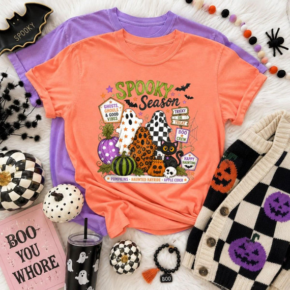 Spooky Season DTF Transfer, Folk Art Halloween Ghosts and Pumpkins design printed on an orange T-shirt with Halloween-themed illustrations and phrases.