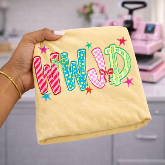 WWJD DTF Transfer, colorful faith-based design with the word 'WILD' in multicolored, patterned letters on fabric.