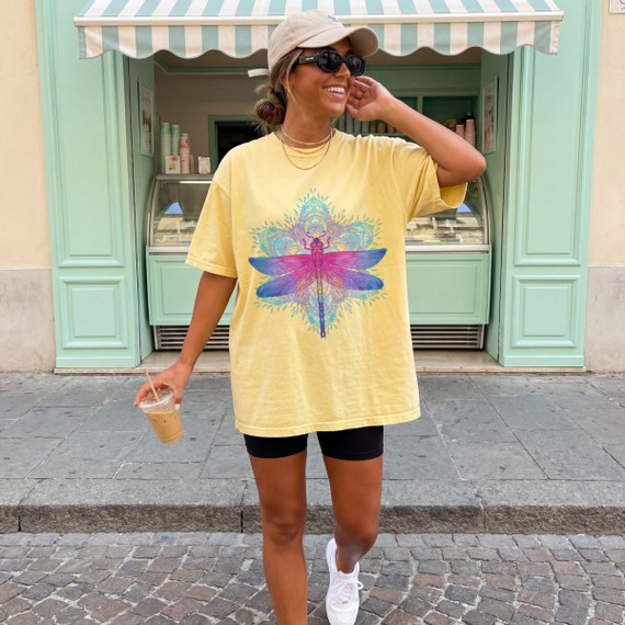 Mandala dragonfly DTF transfer with pink, purple, and teal watercolor design on a yellow t-shirt