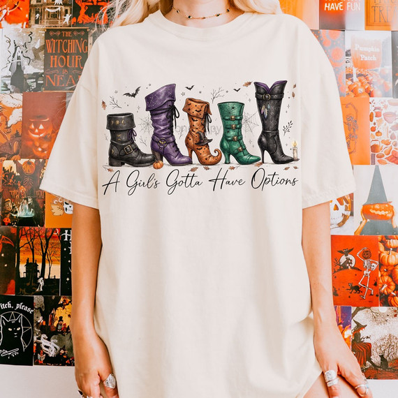 A Girl's Gotta Have Options Halloween DTF transfer featuring five illustrated witch boots in purple, black, green, and orange with script lettering