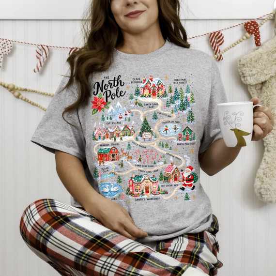 The North Pole map DTF transfer with Santa's Workshop, Elf Village, Reindeer Stables, and Candy Cane Lane illustrated in a festive vintage style