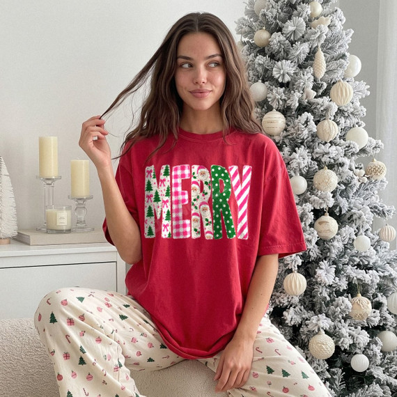 MERRY patchwork DTF transfer with pink gingham, Santa print, green polka dot, and candy cane stripe lettering on a red t-shirt