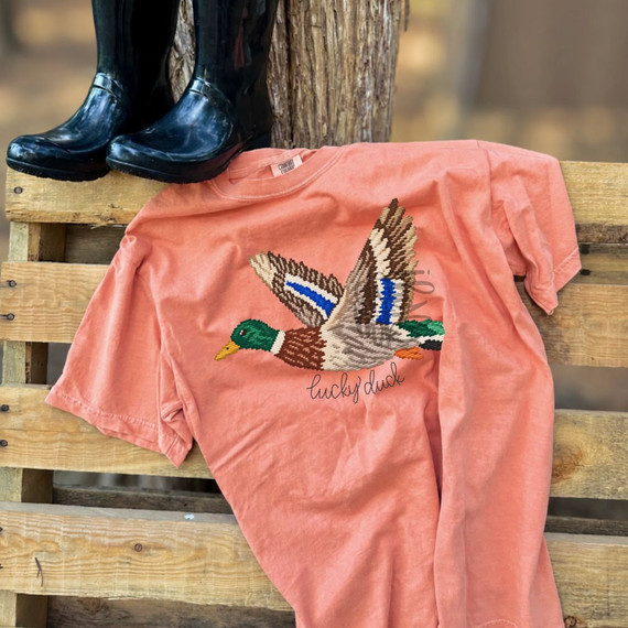 Lucky Duck DTF transfer featuring a flying mallard duck in a stitched-embroidery look with script lucky duck lettering