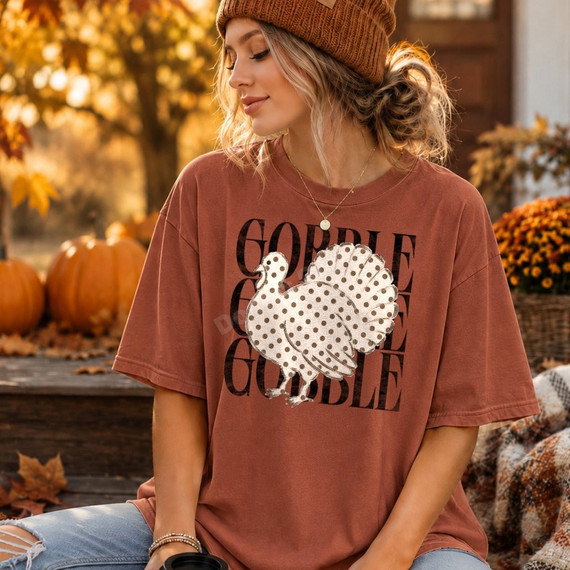 Gobble Gobble Gobble Thanksgiving DTF transfer with a polka dot turkey illustration on a rust colored t-shirt