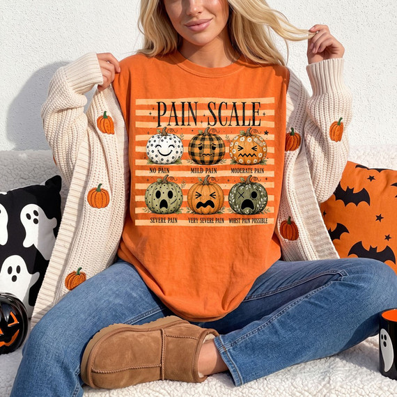 Pain Scale pumpkin DTF transfer on orange shirt with six patterned pumpkin faces ranging from no pain to worst pain possible