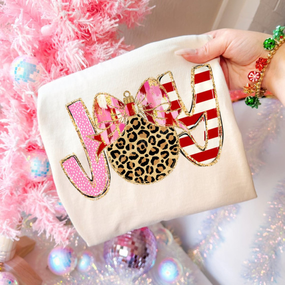 JOY Christmas DTF transfer with leopard print ornament, pink bow, and pink and red striped glitter-style lettering